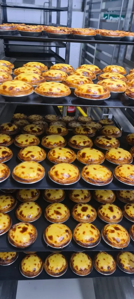 Portuguese egg tarts on bakery racks for a custom hot food vending machine project